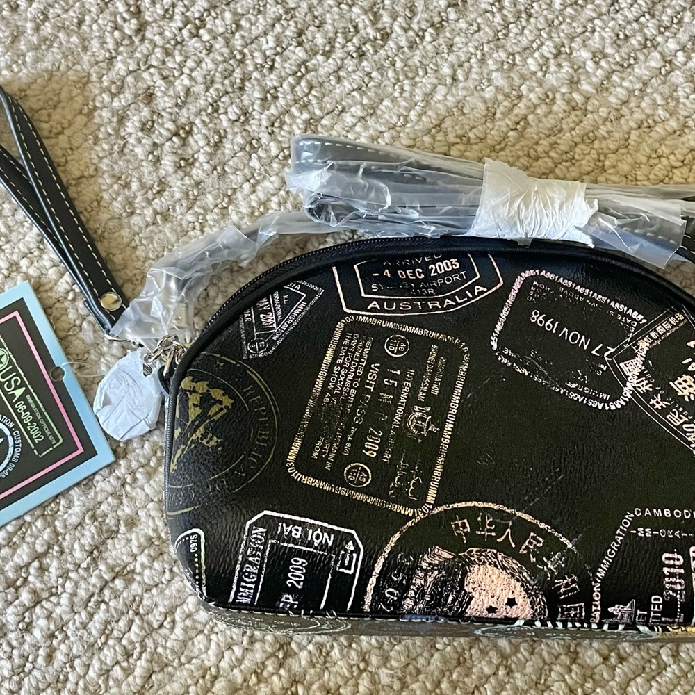 Black Mini bag, can be a wristlet or a crossbody bag. 9” wide by 6“ tall.